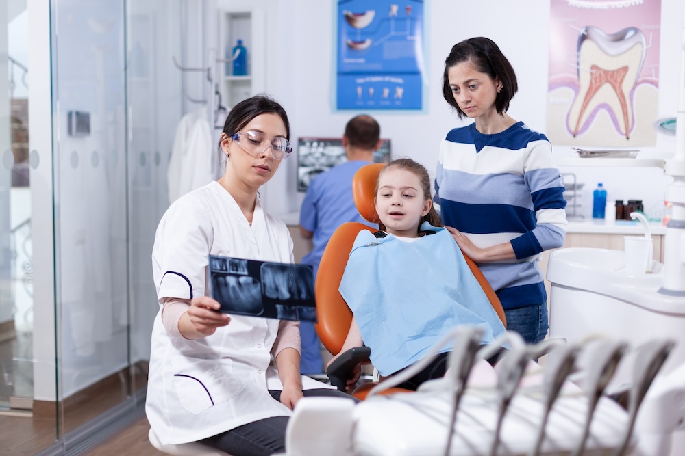 a child and their parent at a dental check up