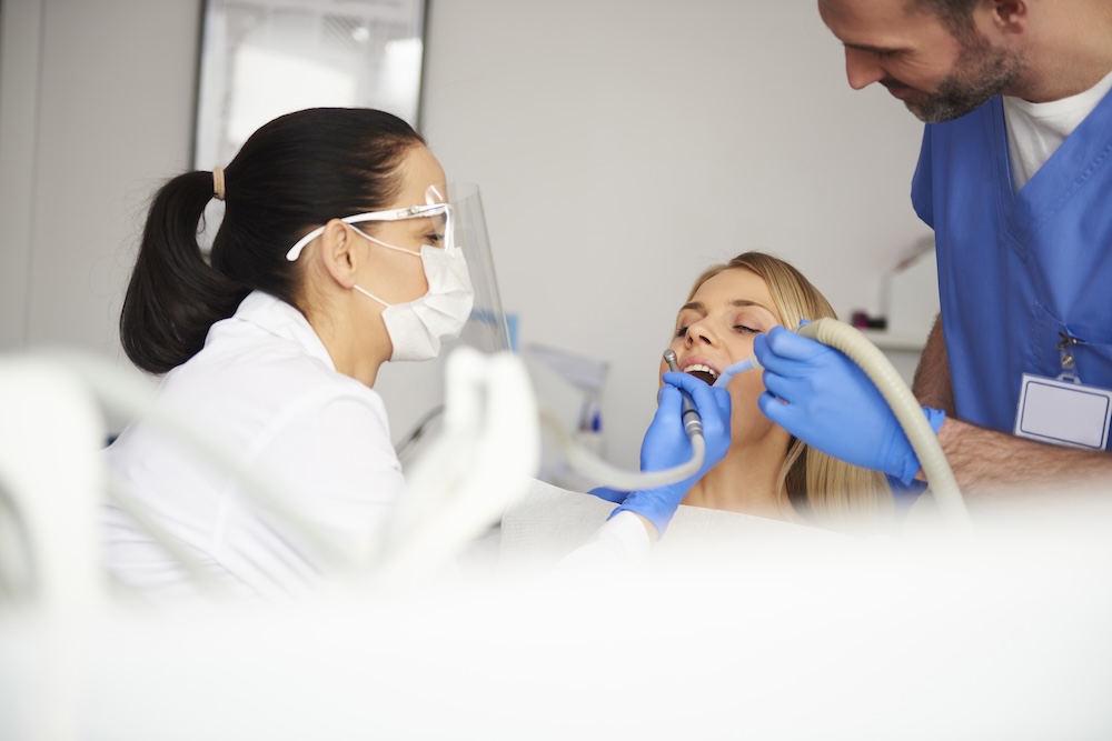 a dentist working on someones teeth