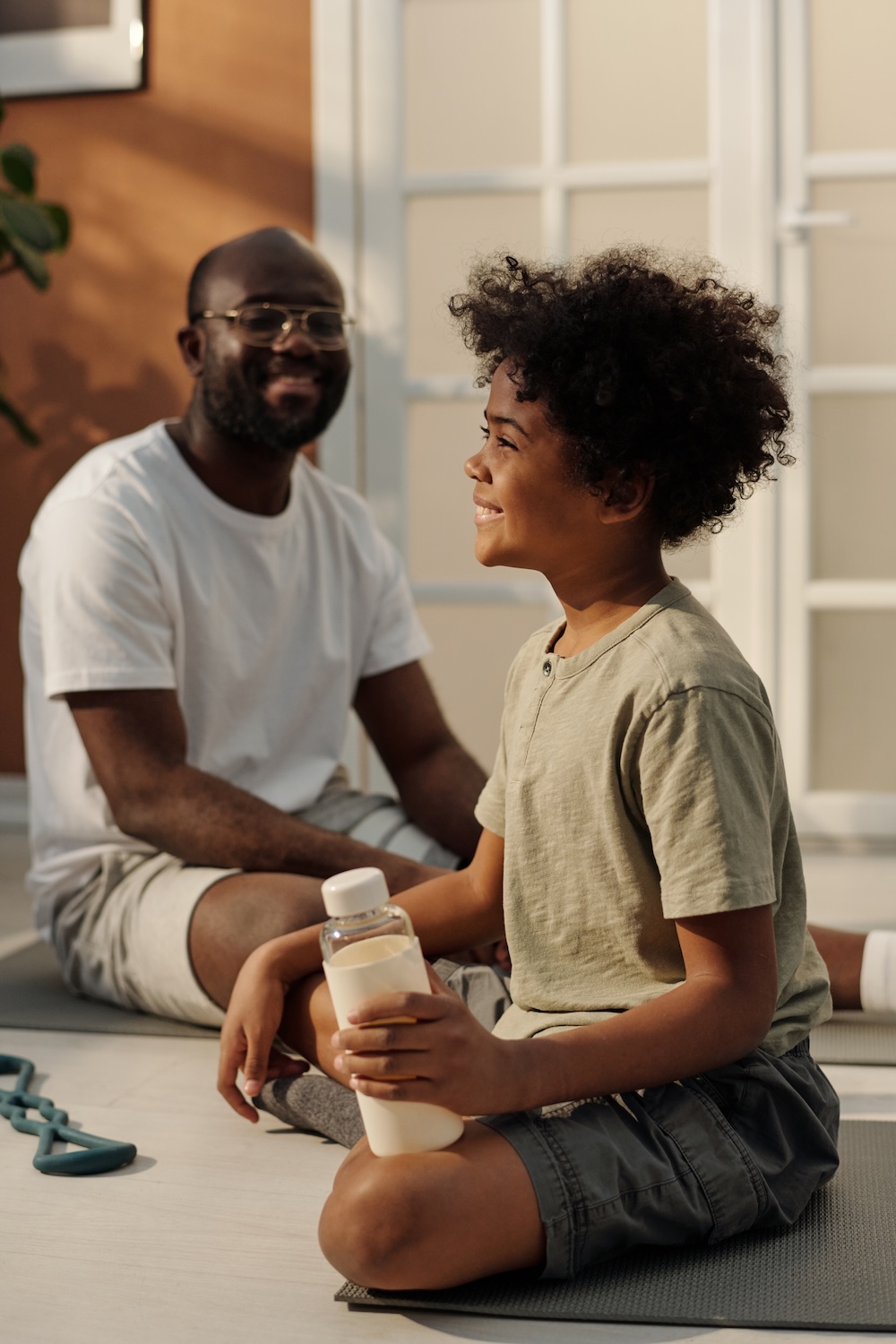 a happy kid sitting with their parent